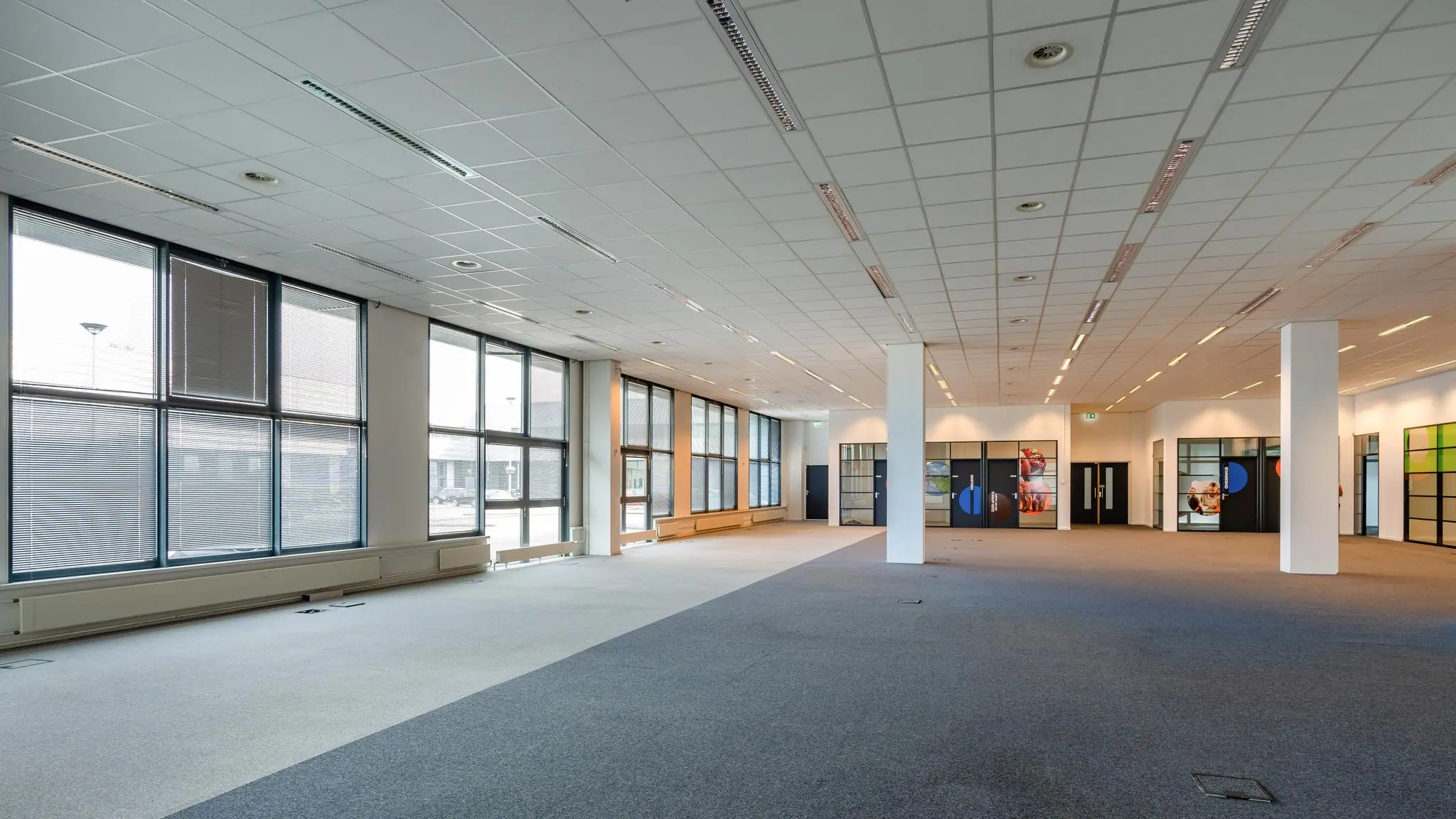 Ruim, modern kantoorpand aan het Rivium Boulevard met grote ramen en systeemplafond.